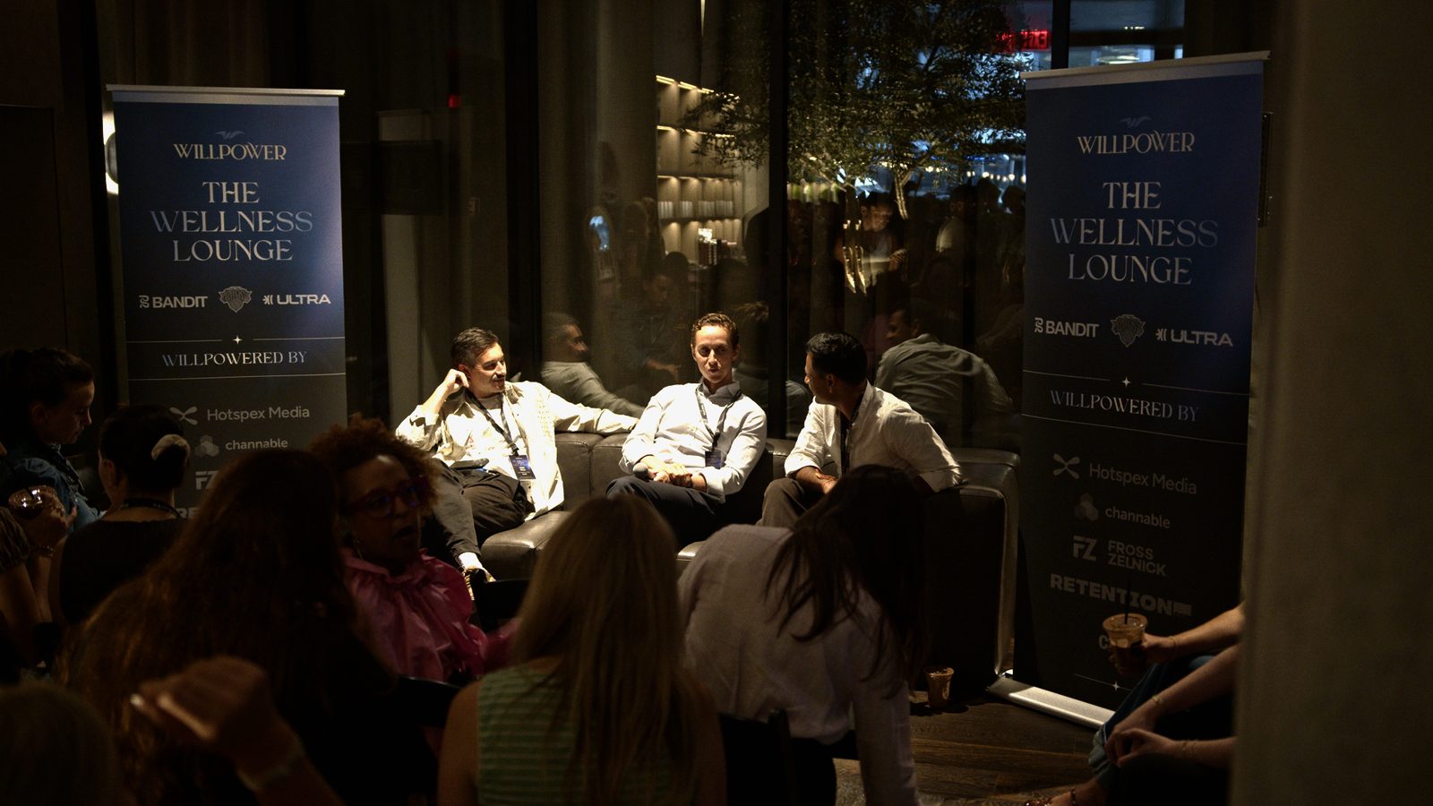 The panel in conversation with the room gathered close