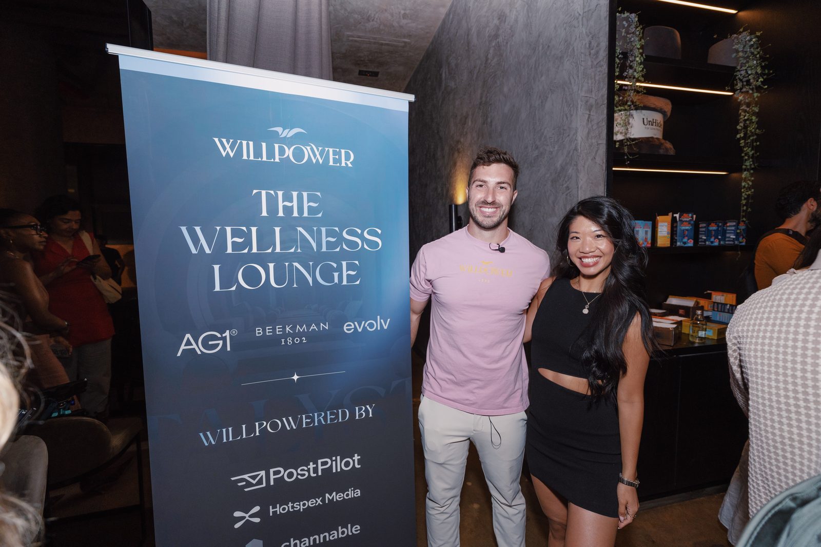 The Wellness Lounge banner with attendees